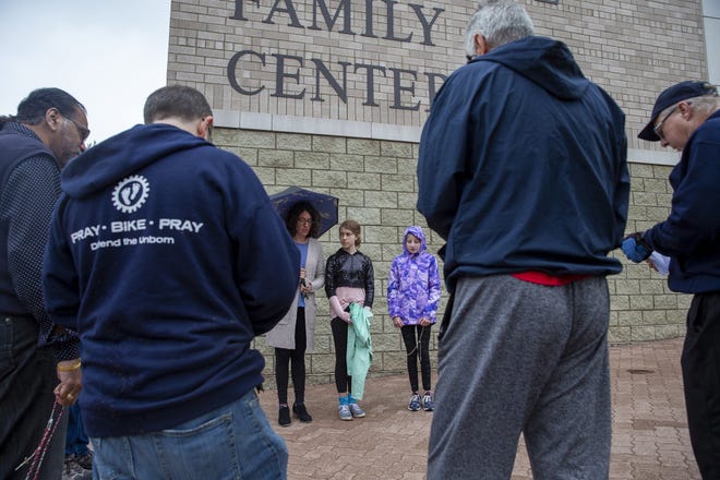 Members of Saints Peter & Paul Catholic Church pray outside the Naperville Fertility Center on September, 28, 2019, in Naperville, Ill. (Camille Fine/Chicago Tribune/TNS)