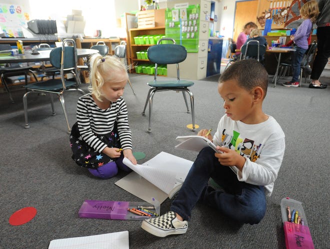 Kindergartners Molly Wimer, left, and Aiden Nunes spend some early afternoon quiet time recently in their classroom at Chatham Elementary School. Nunes is one of four English language learners in teacher Dawn King's class. [Merrily Cassidy/Cape Cod Times]