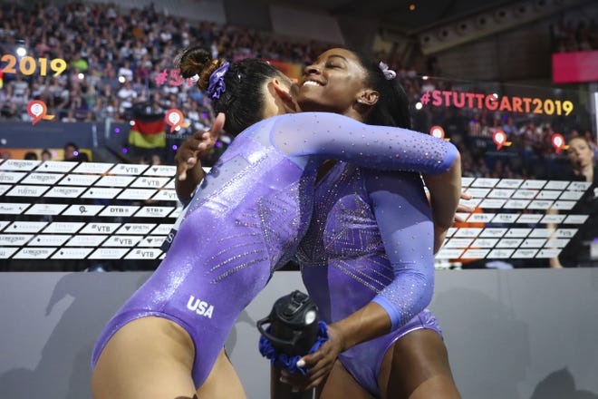 Simone Biles of the United States, right, is hugged by Sunisa Lee of the U.S. after the floor exercise Sunday. [Matthias Schrader/Associated Press]