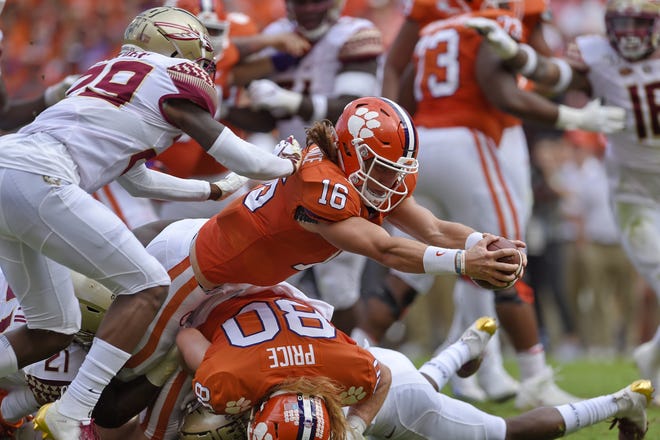Clemson quarterback Trevor Lawrence (16) stretches out for a touchdown against Florida State on Saturday in Clemson, S.C. [AP Photo/Richard Shiro]