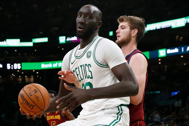 Celtics center Tacko Fall moves to the basket against Cleveland Cavaliers forward Dean Wade during Sunday's preseason game at TD Garden. [The Associated Press]