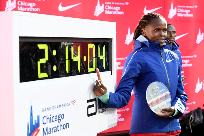 Kenya's Brigid Kosgei poses with her world-record women's time of 2:14:04 at the Chicago Marathon on Sunday. [The Associated Press]