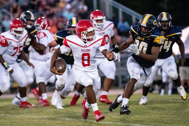 Seventy-First's Jamarious Simmons (9), shown against Cape Fear, passed for two touchdowns, ran for a score and also intercepted a pass as the Falcons snapped a three-game losing streak by beating Lumberton 42-0 on Friday. [Raul F. Rubiera/The Fayetteville Observer]