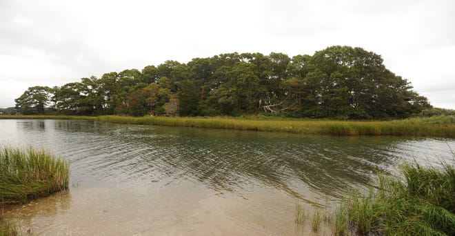 Gooseberry Island in Popponesset Bay is seen from the end of Punkhorn Point Road in Mashpee. A Land Court judge has ruled that the owner of the island also owns a strip of land at the end of Punkhorn Point Road, allowing him to file for approval to build a bridge to the island. [Merrily Cassidy/Cape Cod Times]