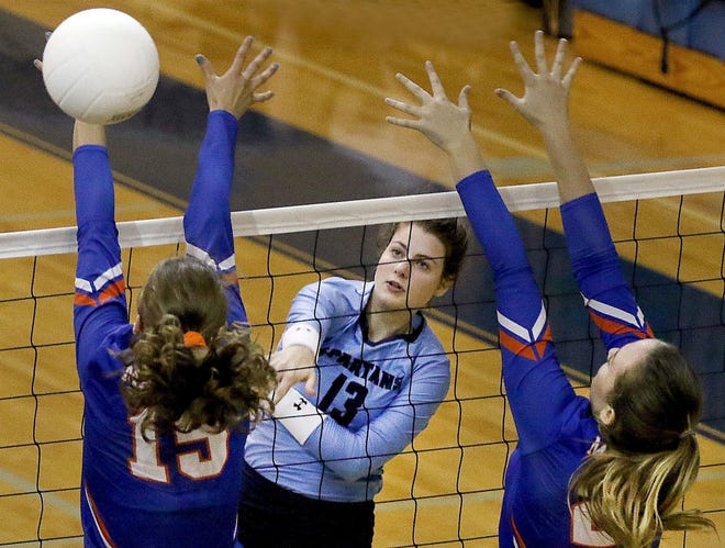 Gaston Day School’s Lauralee Hurst hits the ball past a pair of Marvin Ridge defenders during their match earlier this season. [JOHN CLARK/THE GASTON GAZETTE]