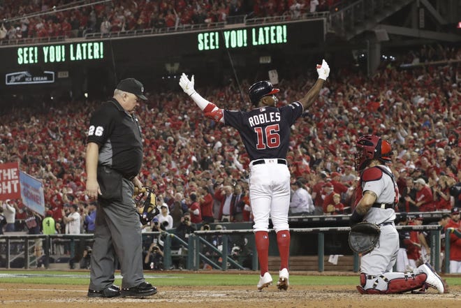 The Washington Nationals' Victor Robles reacts as he crosses home after hitting a home run during the sixth inning of Game 3 of the National League Championship Series against the St. Louis Cardinals on Monday in Washington. [AP Photo/Jeff Roberson]