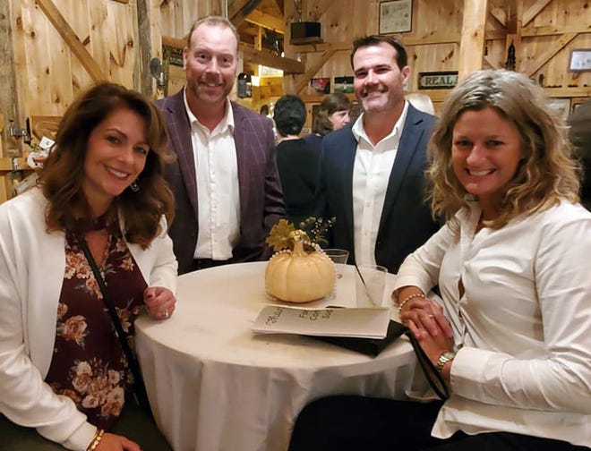 Pictured, from left, are guests Kim Rosebrooks, auction emcee Earl Rosebrooks, Mike Lowell and Jen Heath at Day Kimball Healthcare’s Pumpkins & Pearls Auction and Cocktail Party held Sept. 27 at Ballard Farm in Thompson. [PHOTO PROVIDED/VALENTINE IAMARTINO]