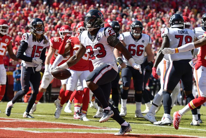 Houston Texans running back Carlos Hyde scores a touchdown during the first half Sunday against the Chiefs in Kansas City, Mo. [The Associated Press]