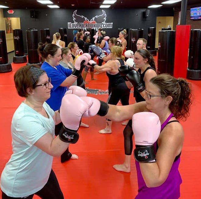 A class works out at iLoveKickboxing.com. [Photo for The Item]