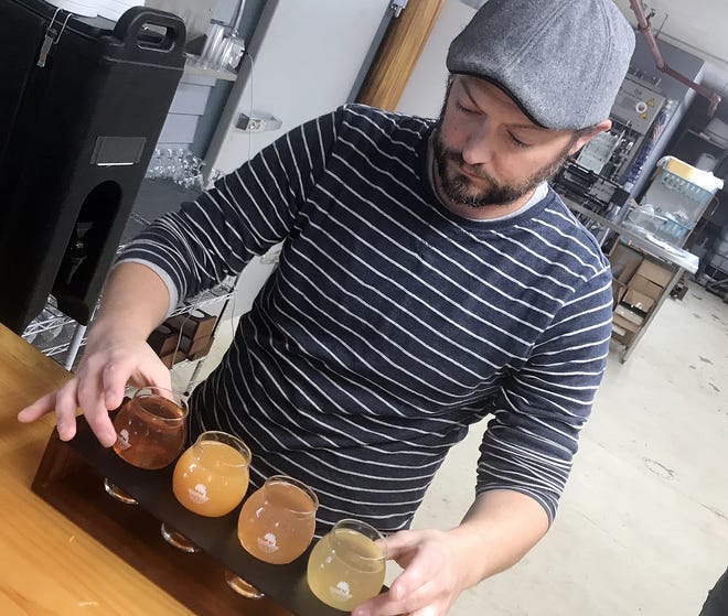 Brian Rock, the head cider maker at Still River Winery and Common Ground Ciderworks in West Brookfield, prepares a flight of cider samples. [T&G Staff/Kim Ring]