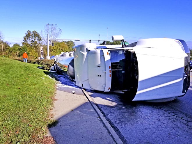 This 18-wheel white Peterbilt truck appeared to be traveling north on Madison Avenue when it turned over onto its passenger’s side around 9 a.m. Monday, spilling about 6,000 gallons of milk. The exact cause of the crash is still under investigation. The driver of the truck was not injured in the crash. (GateHouse Media Ohio/ 

Jack Rooney, The Daily Record)