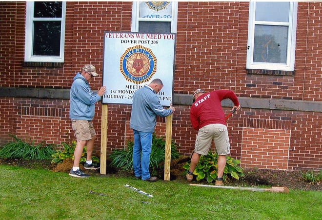 Provided photo

Members of the Dover Parks and Recreation Department install a sign with information about Dover American Legion Post 205 in front of Memorial Hall recently.