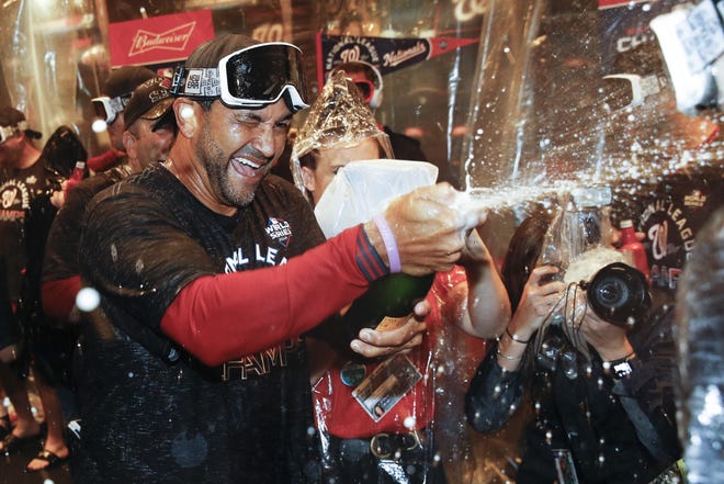 Washington Nationals manager Dave Martinez celebrates after Game 4 of the National League Championship Series against the St. Louis Cardinals early Wednesday in Washington. The Nationals won 7-4 to win the series 4-0. [PATRICK SEMANSKY/THE ASSOCIATED PRESS]