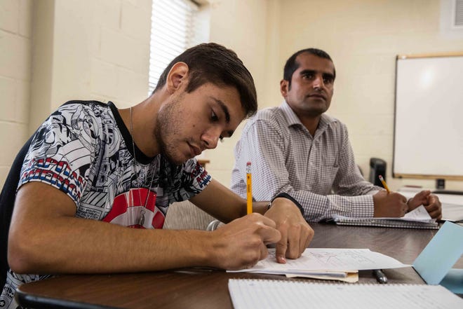 Francisco Saenz (left) from Guatemala and Haroon Kohistani from Afghanistan participate in an ESL class as part of the iACT's refugee program Tuesday. [LOLA GOMEZ / AMERICAN-STATESMAN]