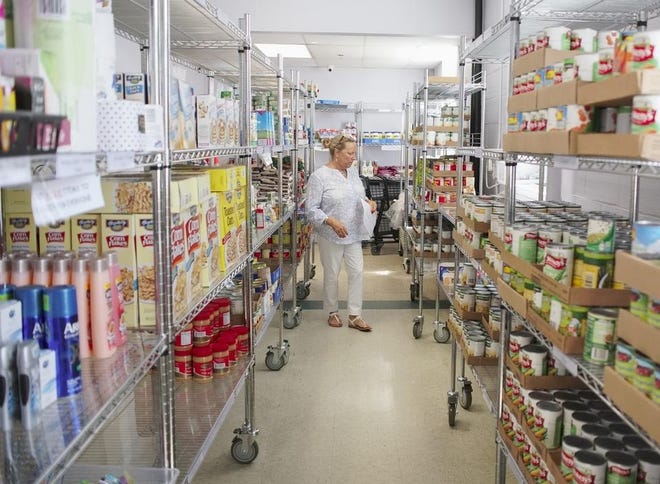 Nancy Harten, director of Hunger Services and the Food 2 Friends program, shops for a homebound client at the MLK Center food pantry. [DAILY NEWS FILE PHOTO]