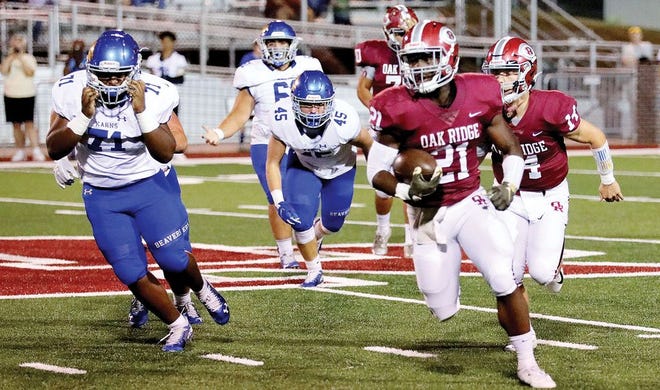 Oak Ridge High School's senior running back/receiver Tyrell Romano (5-10, 193) carries the ball past the Karns Beavers, above, during the Wildcats' homecoming game held at Blankenship Field