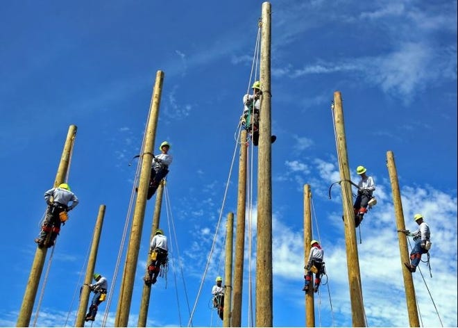 Linemen Academy students practice on poles at Cleveland Community College. The college will partner with Boy Scouts of America to host a young explorers program that gives students a chance to learn about multiple career paths. [File photo by Brittany Randolph / The Star]