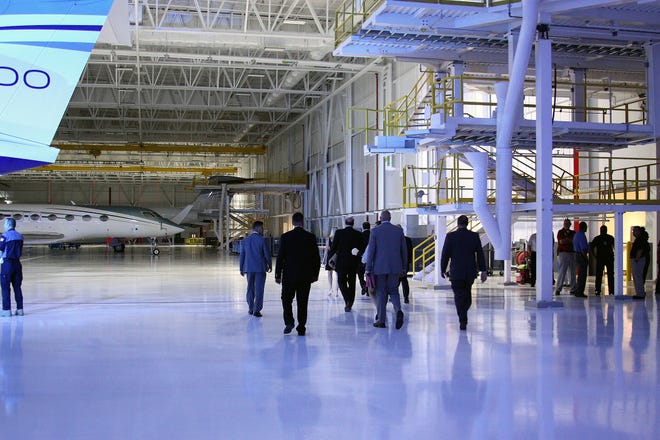 Attendees tour the new hanger at the opening of the Gulfstream East Campus, on the grounds of Savannah/Hilton Head International Airport in September. [Margarita Bourke file photo/savannahnow.com]