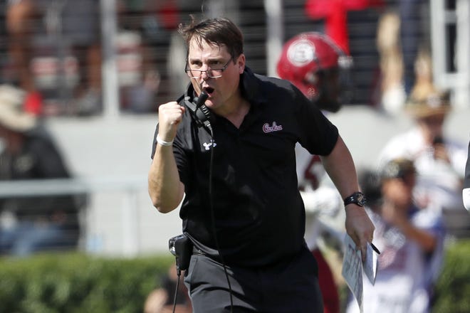 South Carolina head coach Will Muschamp reacts after his team returned an interception for a touchdown in the first half against Georgia on Saturday in Athens. [JOHN BAZEMORE/AP FILE PHOTO]