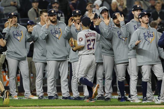 Houston Astros second baseman Jose Altuve celebrates with teammates after their 4-1 win against the New York Yankees in Game 3 of the American League Championship Series on Tuesday night in New York. Game 4 was postponed Wednesday and rescheduled for Thursday night. [MATT SLOCUM/THE ASSOCIATED PRESS]