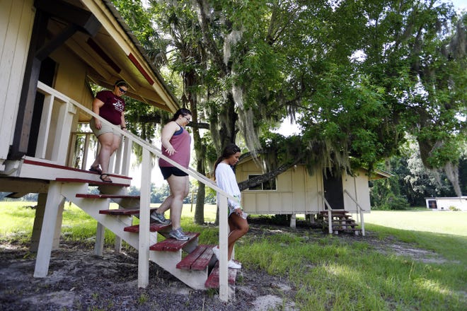 Former Camp McConnell counselors check on the cabins at the camp in the summer of 2014i. .Ther camp is now owned by Alachua County, who is having a hard time selling it to a private entity to run the camp. After a two-year fight to win the right to buy the camp from the county, a South Florida organization known as Friendship Circle says it no longer wants to run a children’s camp on the 212-acre property. [FILE PHOTO BY ERICA BROUGH/SPECIAL TO THE GUARDIAN]