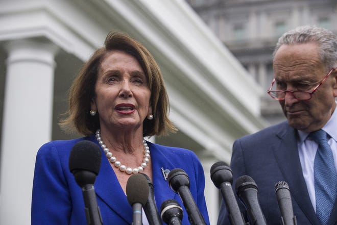 House Speaker Nancy Pelosi of California and Senate Minority Leader Chuck Schumer of New York speak with reporters after a meeting with President Donald Trump at the White House Wednesday. [AP Photo/Alex Brandon]