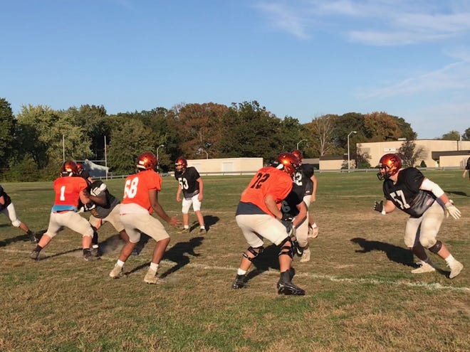 Pennsbury will be counting on its offensive line to win the battle up front against Abington Friday night. Center John Irvine, guard Elijah Slaughter and tackle Andrew Hamacher work in practice on Tuesday. [TODD THORPE/STAFF PHOTOJOURNALIST]