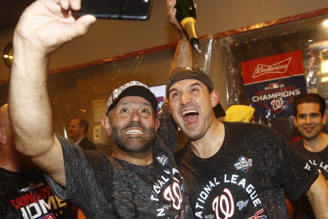 Washington's Ryan Zimmerman and Dr. Hirad Bagy celebrate after Game 4 of the National League Championship Series against St. Louis on Tuesday in Washington. The Nationals won 7-4 to win the series 4-0. [Patrick Semansky/Associated Press]