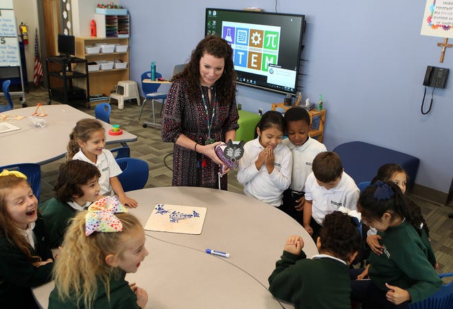 Virginia Baxter talks with her students at St. Michael Catholic School, which recently underwent a $1.6 million renovation project. [JOHN CLARK/THE GASTON GAZETTE]