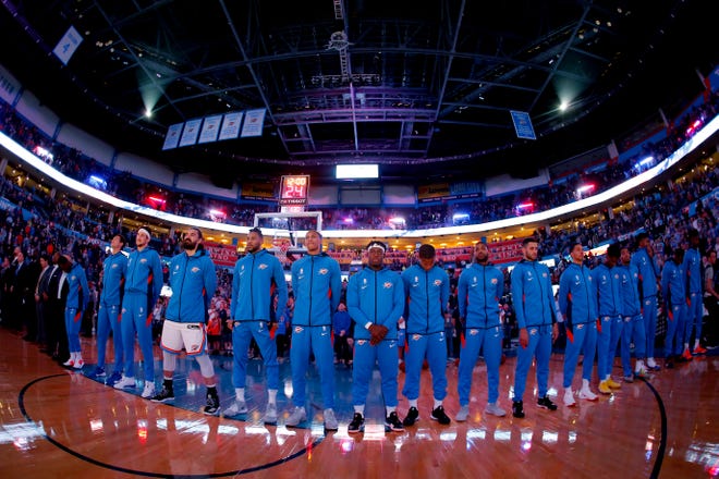 The Oklahoma City Thunder stand during the national anthem before an NBA preseason basketball game between the Oklahoma City Thunder and the Memphis Grizzlies at Chesapeake Energy Arena in Oklahoma City, Wednesday, Oct. 16, 2019. [Bryan Terry/The Oklahoman]