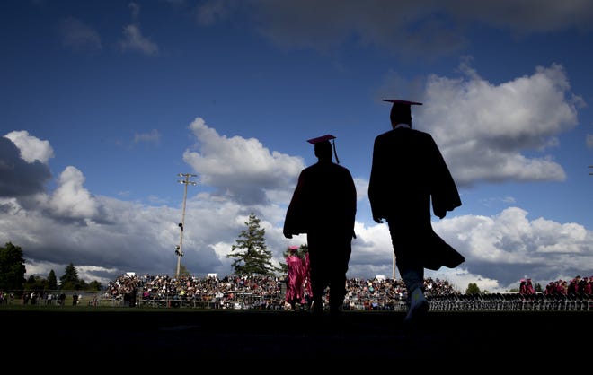 Seniors walk to chairs arranged for their graduation at the Willamette High School. The Oregon Department of Education's annual report cards found more ninth-grade students were on track to graduate within four years than the year before, which means they had completed at least 25% of their class credit requirements at the end of the 2018-2019 school year, which is a major indicator of whether students will graduate on time. [Andy Nelson/The Register-Guard file] - registerguard.com