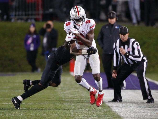 Ohio State Buckeyes wide receiver Binjimen Victor (9) fights for extra yards after a reception during the second quarter of a NCAA Division I college football game between the Northwestern Wildcats and the Ohio State Buckeyes on Friday, Oct. 18, 2019 at Ryan Field in Evanston, Illinois. [Joshua A. Bickel/Dispatch]