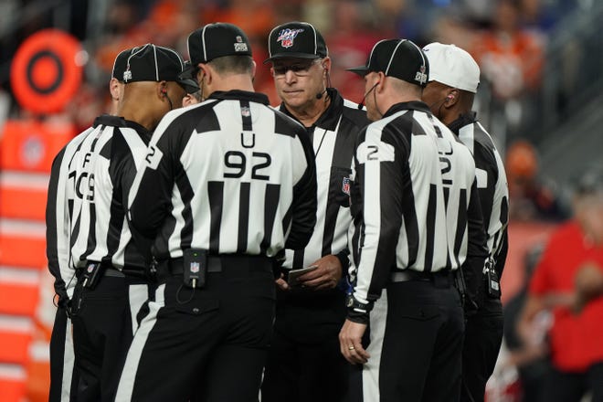 Officials review a call during the first half of Thursday's game between the Kansas City Chiefs and Denver Broncos. [AP Photo/Jack Dempsey]