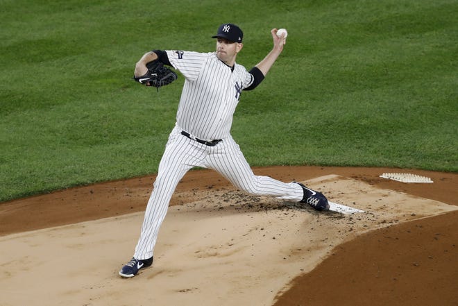 New York Yankees starting pitcher James Paxton throws against the Houston Astros during the first inning in Game 5 of the American League Championship Series on Friday in New York. [KATHY WILLENS/THE ASSOCIATED PRESS]