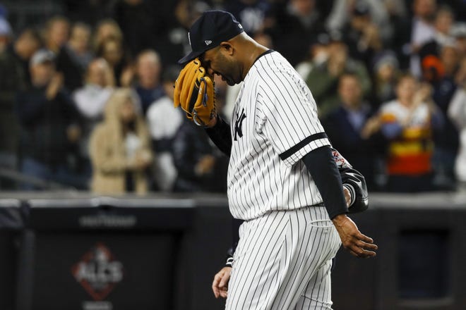 New York Yankees pitcher CC Sabathia is helped off the field during the eighth inning in Game 4 of baseball's American League Championship Series against the Houston Astros on Thursday. [AP PHOTO/MATT SLOCUM]