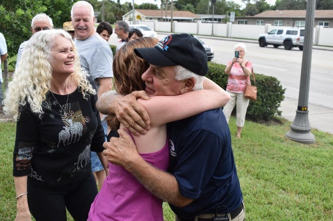 Stephanie Francis, left, and Stephanie Mahoney, center, greet their close friend Ivan Stoltzfus on Saturday after he returned to Sarasota from a cross-country trek in a tractor. [ANNA BRYSON/SARASOTA HERALD-TRIBUNE]