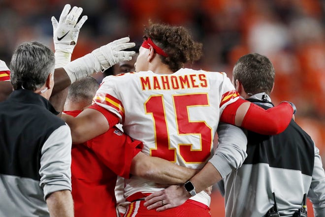 Kansas City Chiefs quarterback Patrick Mahomes leaves the game after getting injured against the Denver Broncos during the first half Thursday night in Denver. [David Zalubowski/The Associated Press]