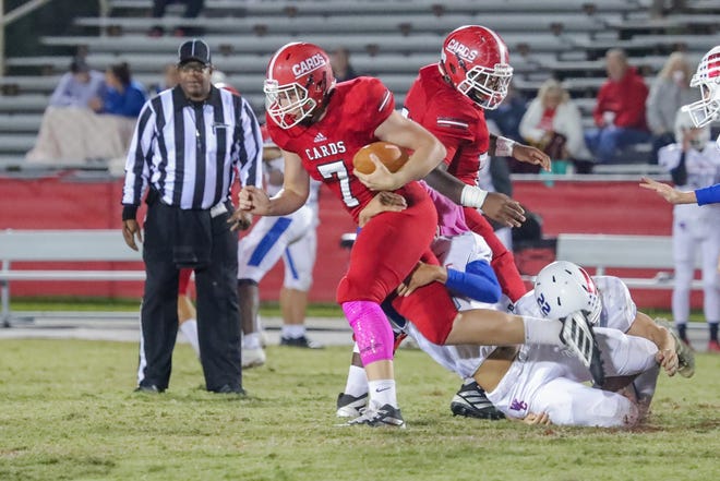 Jacksonville's Adam Varner breaks a tackle in the Cardinals' 49-10 win over West Carteret on Friday. [Tina Brooks / The Daily News]