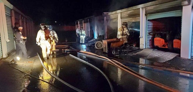 Ocala police officers and firefighters work at the scene of a fire involving units at Store Right Self Storage, 2401 SW 17th Road, on Friday. [Photo courtesy of Ocala Fire Rescue]