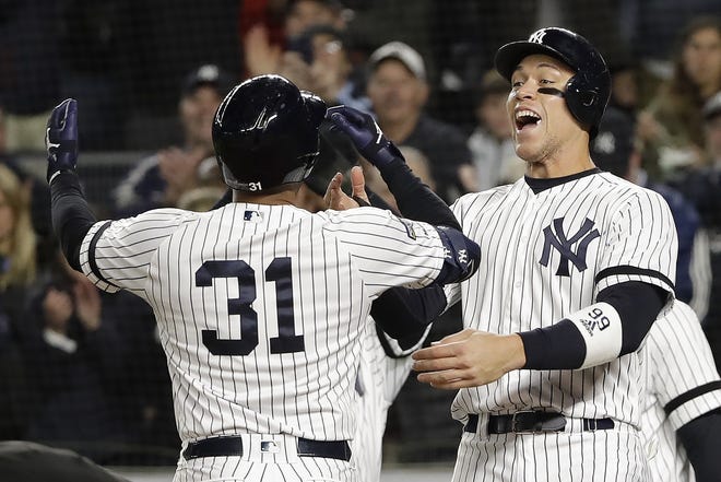 New York Yankees center fielder Aaron Hicks (31) celebrates with Aaron Judge after hitting a three-run home run against the Houston Astros during the first inning of Game 5 of the American League Championship Series on Friday night in New York. [FRANK FRANKLIN II/THE ASSOCIATED PRESS]