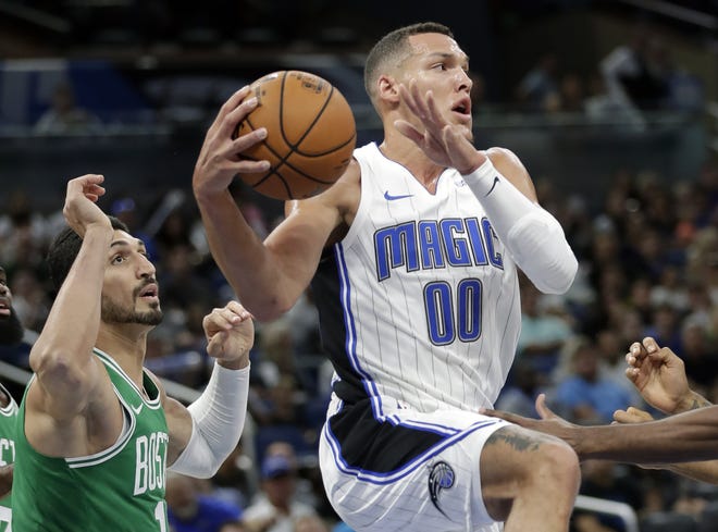 Orlando Magic's Aaron Gordon (00) looks to pass the ball as he is guarded by Boston Celtics' Enes Kanter, left, during a preseason game Oct. 11 in Orlando. [AP Photo/John Raoux]