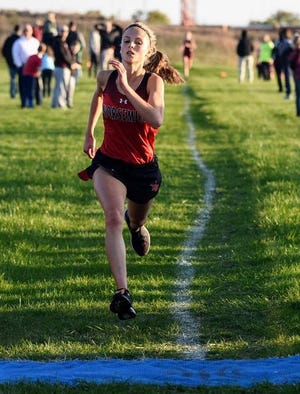 Roland-Story’s Kylie Tjernagel sprints toward the finish line during the varsity girls’ race at the Heart of Iowa Conference cross country meet Oct. 14 in Alleman. Tjernagel placed second with a personal-record time of 19 minutes, 58 seconds to earn all-conference honors.