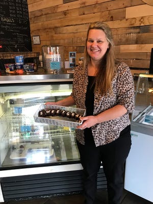Lori Granniss sells her Sweetgrams - messages spelled out on chocolate dipped strawberries - at KIND Coffee in Boiling Springs. [Special to The Star]