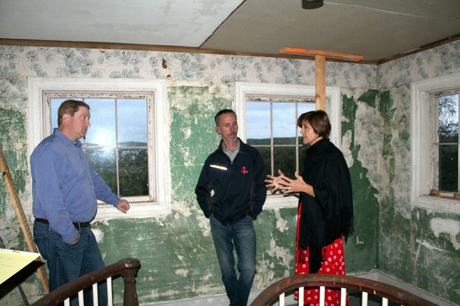 Boylston selectmen Matt Mecum and James Underwood discuss potential for the Gough House with Hillside Restoration Project member Nel Lazour during a recent tour of the historical home of former temperance leader John Gough. [Item Staff / KEN CLEVELAND]