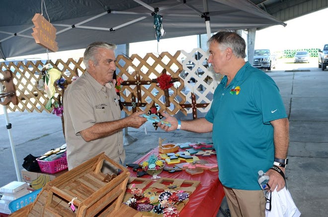 Charles Geno Marsala, President of the American Italian Federation of the Southeast and producer of AWE.News, visits the Festa Italiana Saturday afternoon at the Frank Sotile Pavilion in Donaldsonville.