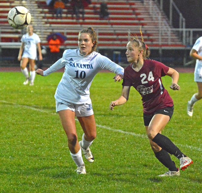 Addison's Gabby Coletta and Gananda's Lindsey Wunder eye down the ball Tuesday. [TOM PASSMORE/THE LEADER]