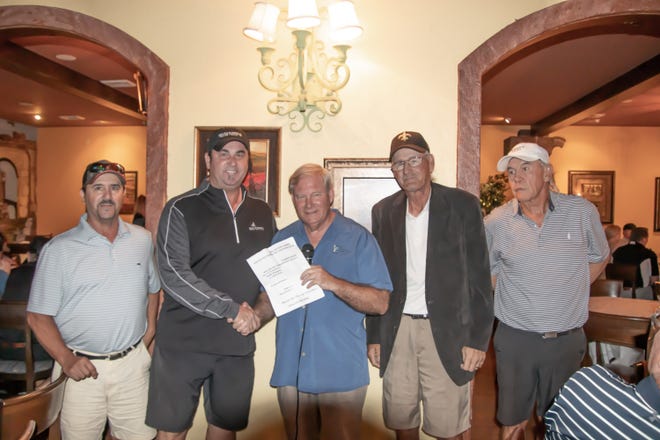 Ken Hair, Children In Crisis president/CEO (center), presents the first place prize to the winning foursome from the recent Sugar Sands Charity Golf Classic benefiting Children In Crisis — (from left) Mike Davis, Rich Chase, John Hicks and David Boyd. Almost 100 golfers participated in the event. [CONTRIBUTED PHOTO]