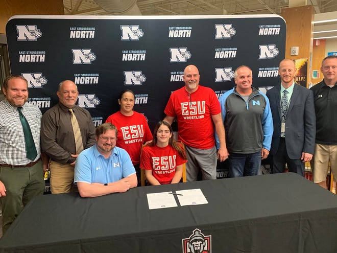 Avia Bibeau, front center, signed a letter of intent to continue her wrestling and academic career at East Stroudsburg University. [PHOTO PROVIDED]