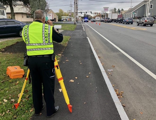 Taunton police crash reconstruction investigator Lt. Paul Roderick takes measurements near Harts Four Corners after a city man was killed last Thursday in a two-vehicle collision.

Taunton Gazette photo by Charles Winokoor