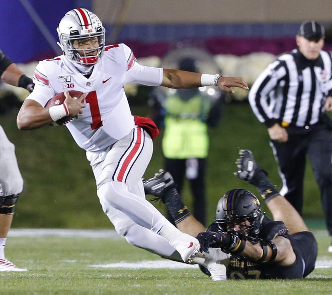 Quarterback Justin Fields' ability to scramble has helped Ohio State convert on third downs this season. [Adam Cairns/Dispatch]